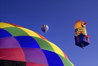 USA, New Mexico, Albuquerque, Annual balloon fiesta colourful hot air balloons ascending with part