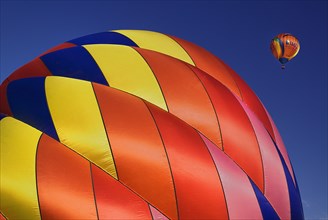 USA, New Mexico, Albuquerque, Annual balloon fiesta colourful hot air balloons with part view of