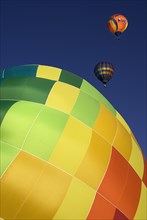 USA, New Mexico, Albuquerque, Annual balloon fiesta colourful hot air balloons with part view of