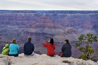 USA, Arizona, Grand Canyon, Group of people observing the South Rim viewed from Yavapai Point.