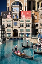 USA, Nevada, Las Vegas, The Strip tourists in gondola outside the entrance to the Venetian hotel