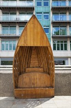 England, London, Vauxhall Albert embankment benches made from wood in the shape of boats. 
Photo :