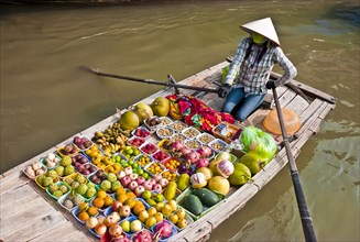 Vietnam, North, Markets, Floating market woman selling fruit & vegetables from a boat. 
Photo :