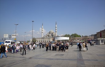 Turkey, Istanbul, Eminonu Yeni Camii New Mosque main square with people walking through. 
Photo :