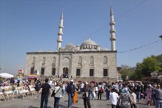 Turkey, Istanbul, Eminonu Yeni Camii New Mosque with people selling goods to the tourists in the