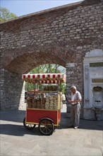 Turkey, Istanbul, Sultanahmet bread snack vendor at the entrance to Topkapi Palace Gardens. 
Photo