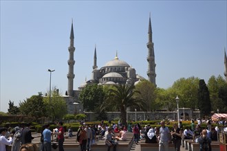 Turkey, Istanbul, Sultanahmet Camii Blue Mosque with tourists sat outside. 
Photo : Stephen