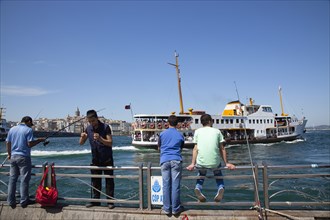 Turkey, Istanbul, Eminonu people fishing the Bosphorus sea from the quayside. 
Photo : Stephen
