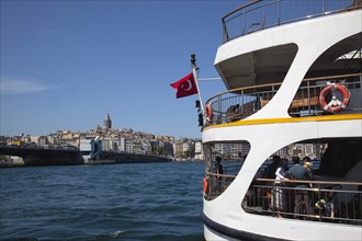 Turkey, Istanbul, Eminonu view across the Golden Horn toward Galata district. White ferry carrying