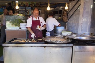 Turkey, Istanbul, Karakoy Galata fish market stall selling fried fish snacks. 
Photo : Stephen