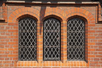 England, West Sussex, Arundel, Detail of red brick building with lead light windows. 
Photo :