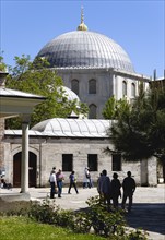 Turkey, Istanbul, Sultanahmet Haghia Sophia Sightseeing tourists in the grounds with the dome