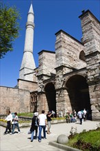 Turkey, Istanbul, Sultanahmet Haghia Sophia Minaret with sightseeing tourists entering the Outer