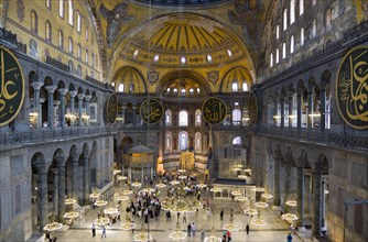 Turkey, Istanbul, Sultanahmet Haghia Sophia Sighseeing tourists beneath the dome with murals and