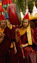 Buddhist Monk playing a drum in a Losar ceremonial procession, Sikkim, India