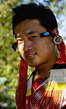 PORTRAIT OF A TRIBAL FROM A NAGA WARRIOR TRIBE WEARING TRADITIONAL COSTUME AND JEWELRY, NAGALAND, NORTH EAST INDIA