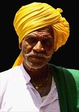 PORTRAIT OF A LAMBANI GYPSY TRIBAL MAN WITH TRADITIONAL TURBAN COSTUME, INDIA. (MR)