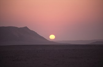 Namibia, Namib Naukluft National Park, Sunset in the Namib Naukluft desert. Access is restricted