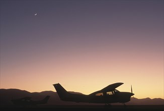 Namibia, North, Transport, A cessna aircraft in the desert silhouetted at sunset. 
Photo : Adrian