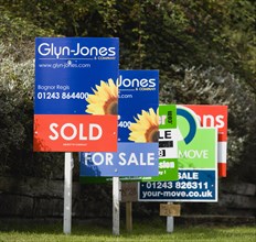 Business, Finance, Real Estate, Estate agents signs on posts advertising property for sale and sold