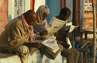 Varanasi Men reading newspapers in the street.