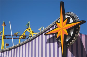 Facade of amusement arcade in clear blue sky.