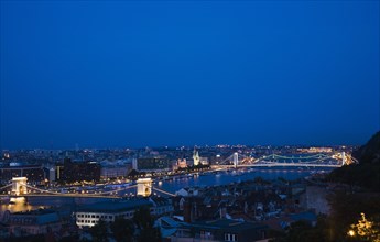 Buda Castle District: view over Danube and Pest with Memorial Chain Bridge illuminated.