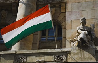 Hungarian Flag flying with Art Nouveau facade behind in central Pest.