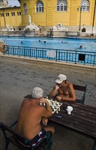 Pest Bathers playing chess in summer at Szechenyi thermal baths largest in Europe.
