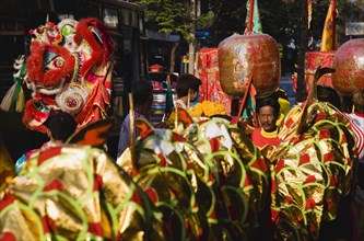 Dragon and Chinese Lanterns carried in parade celebrating local temple.