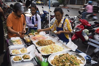Street vendor sells take away Pad-thai the national fried noodle classic dish.