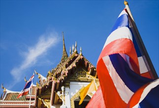 Flag of Thailand with Wat Yannawa behind.