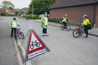 School children being taught cycle safety lessons on public roads.