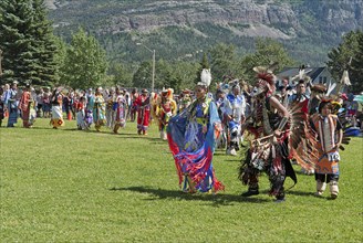Grand Entry of dancers in full regalia at the Blackfoot Arts & Heritage Festival Pow Wow organized by Parks Canada and the Blackfoot Canadian Cultural Society at this UNESCO World Heritage Site Mount ...