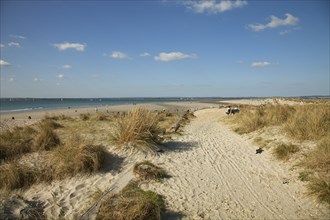 West Wittering Beach View across sand dunes towards beach and sea at East Head. Sunshine and blue sky.