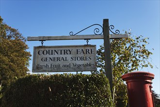 Village store sign and red postbox