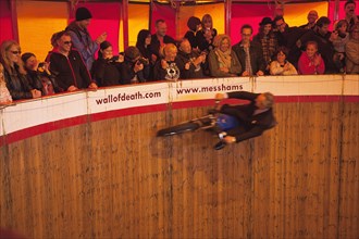 Wall of death motorcycle fairground attraction on Madeira Drive during motorbike festival.