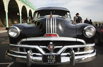 Old American Pontiac automobile on Madeira Drive during classic car festival.