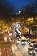 Rush hour traffic along the Embankment with St Paul's Cathedral in the background.