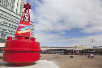 Donegall Quay New office development on the banks of the river Lagan with red buoy in the foreground.