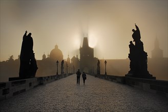 Strolling in the post dawn rays of sun and mist on Charles Bridge.