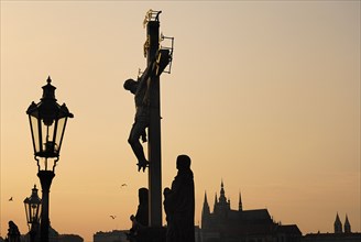 Charles Bridge Calvary with St Vitus in the background at dusk.