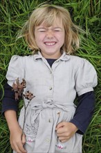 5 year old Eva lying in the grass.