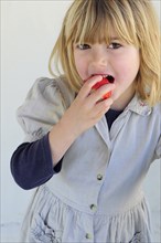5 year old Eva eating first strawberries of the year in February.