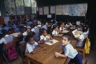 Jamaica, Children, Education, Children at desks in classroom. Photo : David Cumming