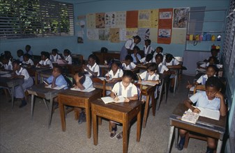 West Indies, Jamaica , Children, Children at desks in school classroom. Photo : David Cumming
