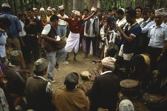 Nepal, Festivals, Male musicians and dancers at Dasain Mela festival in the woods. Photo : Liba