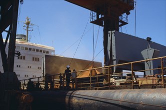 West Indies, Jamaica, Port Kaiser, Loading bauxite onto container ship. Photo : John Wright