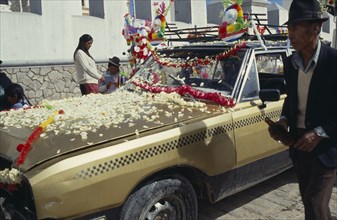 Bolivia, La Paz, Copacabana, Car blessing ceremony. Car with bonnet covered with flower petals.