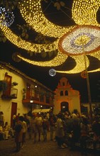 Colombia, Antioquia, Medellin, Christmas lights at Cerro Nutibara. Crowds in small cobbled square